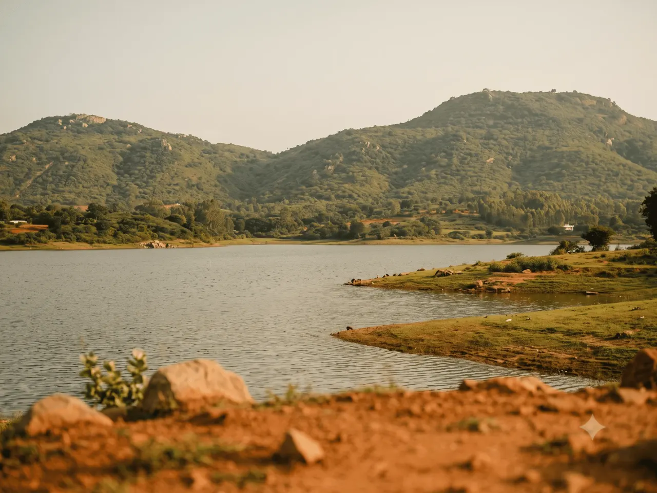 Hosur Lake with green hills in the background